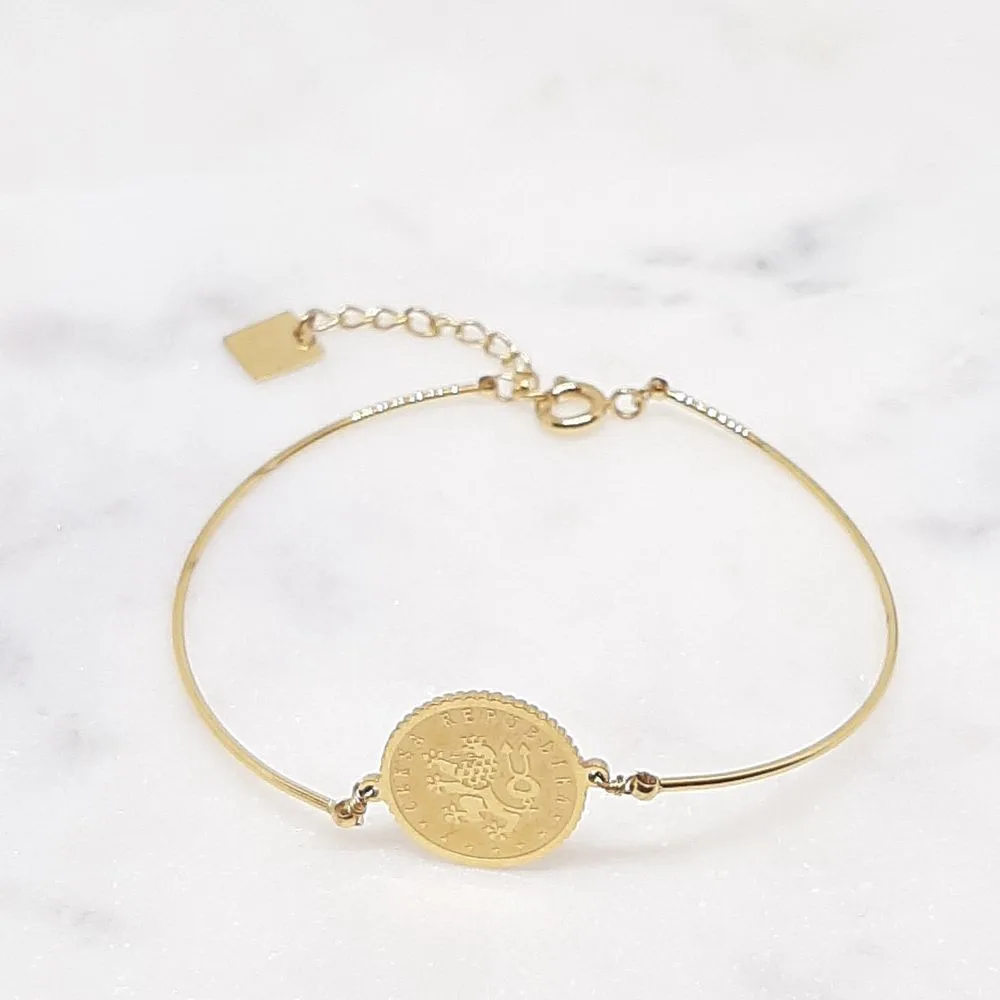 Bracelet jonc avec médaille dorée